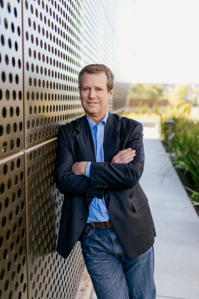 David Jacobs standing and leaning on a wall