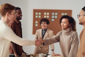 Businesspeople shaking hands after a deal