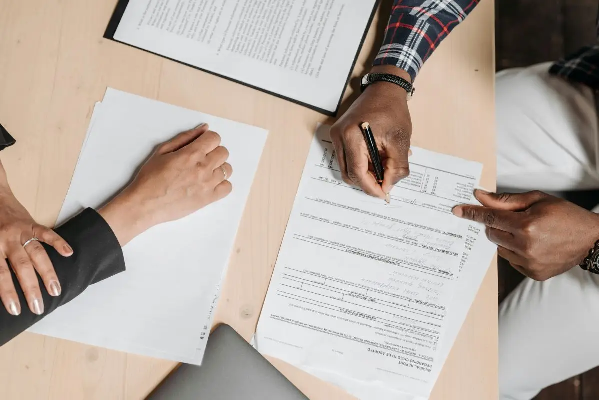 People signing business contract