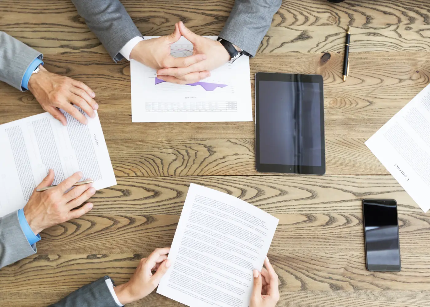 Group discussing asset purchase agreement