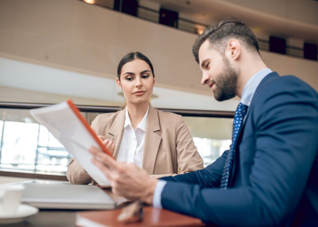 Man and woman negotiating business sale terms